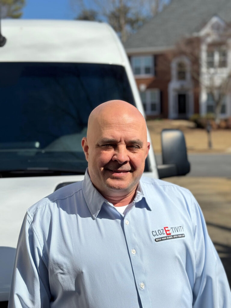 Clozetivity franchise owner standing in front of a branded Clozetivity van