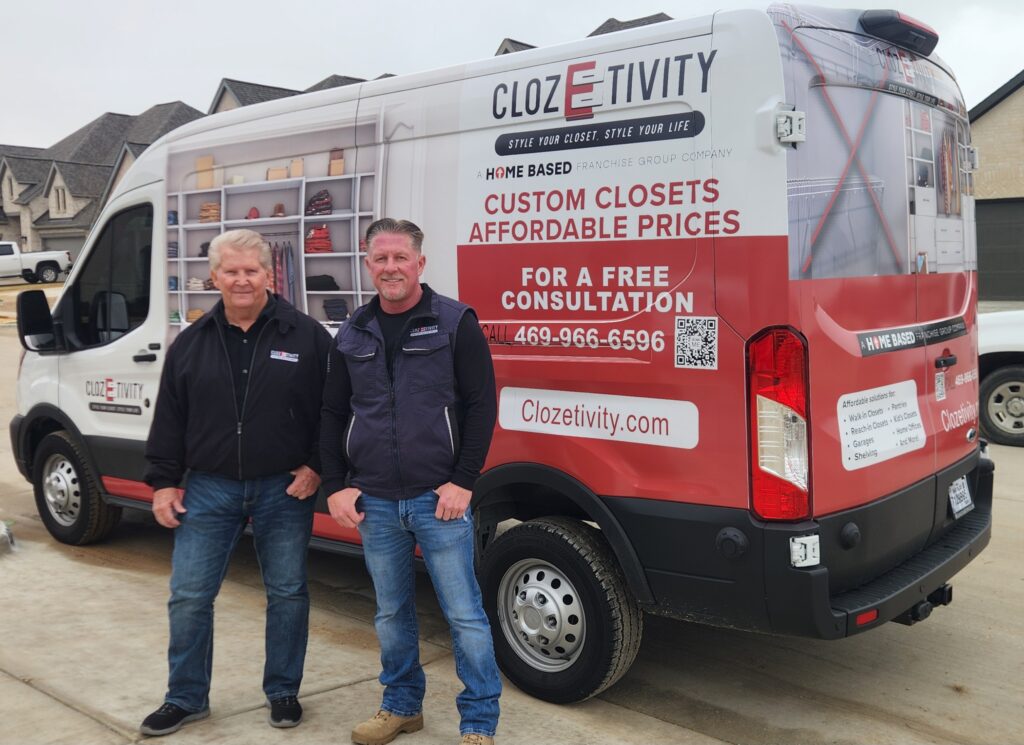 Father and son Clozetivity franchise owners standing in front of a branded Clozetivity van